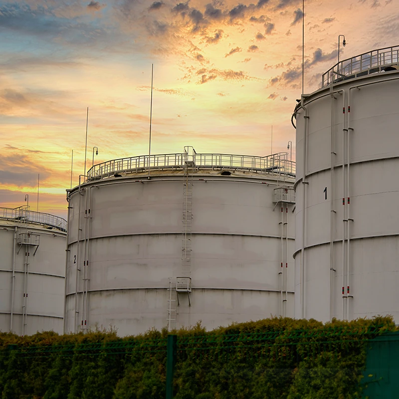large oil drums at sunset